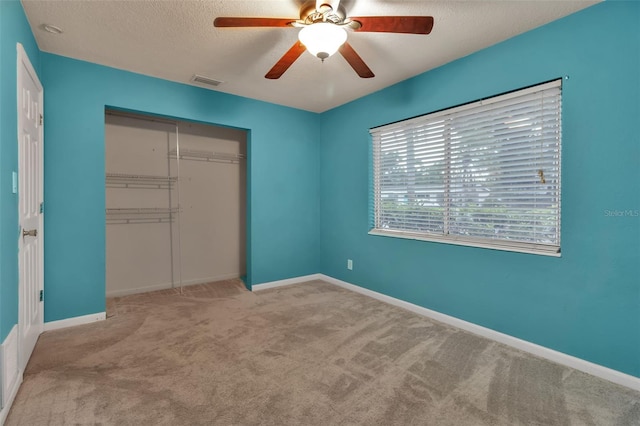6439 Lafayette Rd, Bradenton, FL 34207 - unfurnished bedroom featuring carpet floors, a closet, a textured ceiling, and a ceiling fan