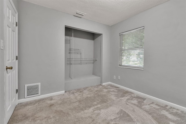 6439 Lafayette Rd, Bradenton, FL 34207 - unfurnished bedroom featuring carpet floors, a textured ceiling, and a closet