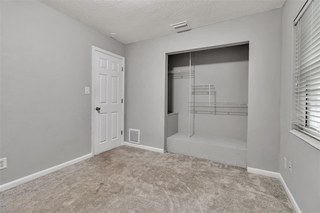6439 Lafayette Rd, Bradenton, FL 34207 - unfurnished bedroom featuring carpet flooring, a closet, and a textured ceiling