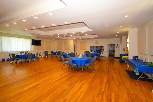 6439 Lafayette Rd, Bradenton, FL 34207 - dining area with wood finished floors, a tray ceiling, and recessed lighting