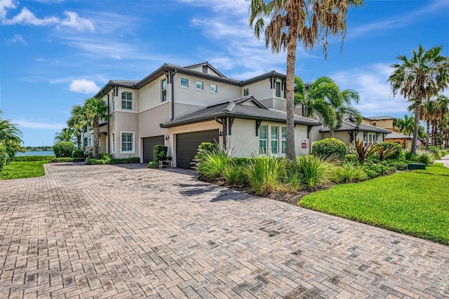 1226 Riverscape St, Bradenton, FL 34208 - view of front facade with stucco siding, decorative driveway, a front yard, and a garage