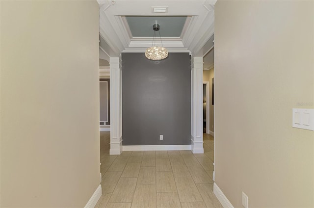 1226 Riverscape St, Bradenton, FL 34208 - hallway with a tray ceiling, a chandelier, crown molding, decorative columns, and light wood-style flooring