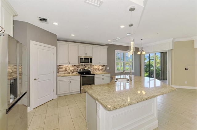 1226 Riverscape St, Bradenton, FL 34208 - kitchen with stainless steel appliances, backsplash, white cabinets, decorative light fixtures, and ornamental molding