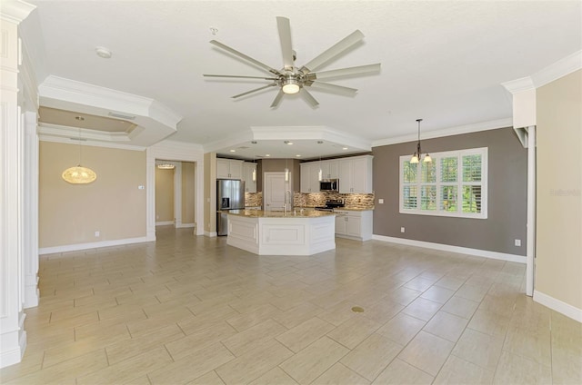 1226 Riverscape St, Bradenton, FL 34208 - kitchen featuring open floor plan, stainless steel appliances, crown molding, a ceiling fan, and decorative backsplash