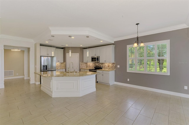 1226 Riverscape St, Bradenton, FL 34208 - kitchen featuring appliances with stainless steel finishes, backsplash, ornamental molding, a chandelier, and light stone counters