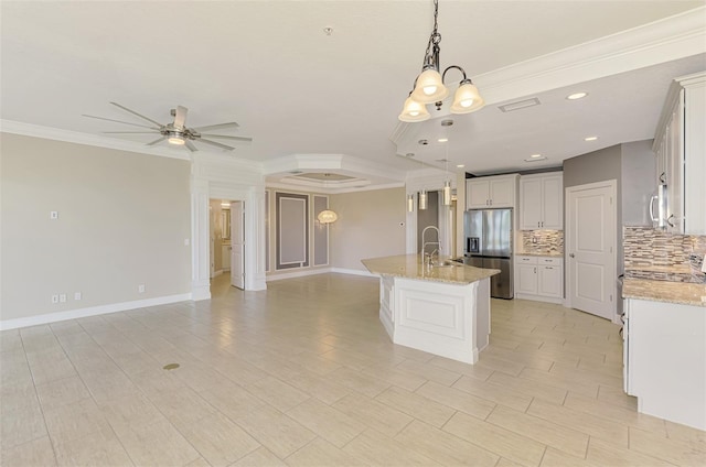 1226 Riverscape St, Bradenton, FL 34208 - kitchen featuring appliances with stainless steel finishes, tasteful backsplash, crown molding, open floor plan, and a chandelier