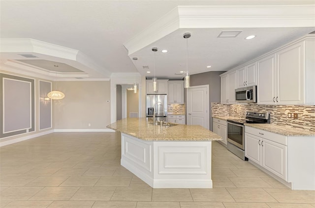 1226 Riverscape St, Bradenton, FL 34208 - kitchen with stainless steel appliances, backsplash, an island with sink, decorative light fixtures, and light stone countertops