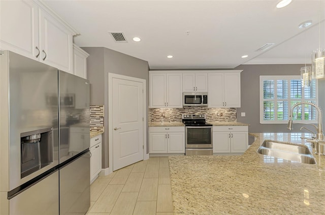 1226 Riverscape St, Bradenton, FL 34208 - kitchen featuring stainless steel appliances, white cabinetry, backsplash, recessed lighting, and crown molding