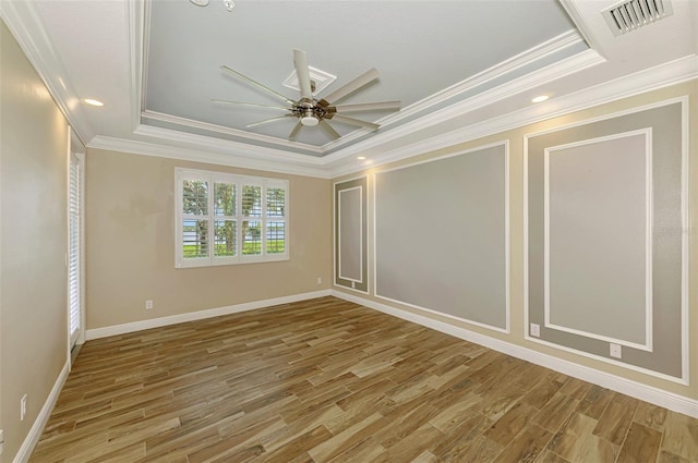 1226 Riverscape St, Bradenton, FL 34208 - empty room featuring a tray ceiling, crown molding, light wood-type flooring, a ceiling fan, and recessed lighting