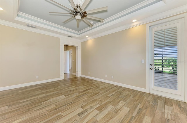 1226 Riverscape St, Bradenton, FL 34208 - empty room with a tray ceiling, a ceiling fan, light wood-style floors, crown molding, and recessed lighting