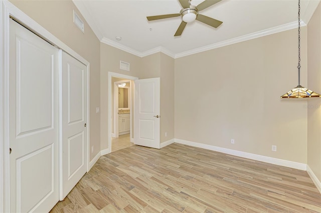 1226 Riverscape St, Bradenton, FL 34208 - unfurnished bedroom featuring ornamental molding, light wood-style floors, a closet, and a ceiling fan