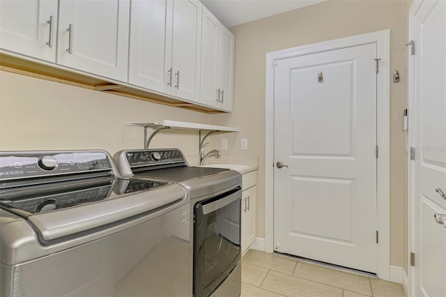 1226 Riverscape St, Bradenton, FL 34208 - laundry room featuring washer and clothes dryer, cabinet space, and light tile patterned floors