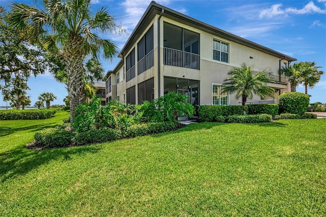 1226 Riverscape St, Bradenton, FL 34208 - rear view of house with stucco siding and a lawn