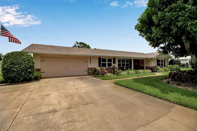 1907 76th St NW, Bradenton, FL 34209 - ranch-style home with brick siding, concrete driveway, an attached garage, and a front lawn
