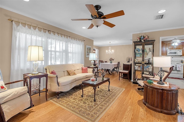 1907 76th St NW, Bradenton, FL 34209 - living room with ceiling fan, crown molding, a chandelier, light wood-style floors, and recessed lighting