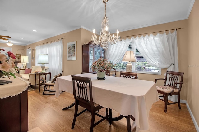 1907 76th St NW, Bradenton, FL 34209 - dining room featuring light wood-style flooring, a chandelier, and crown molding