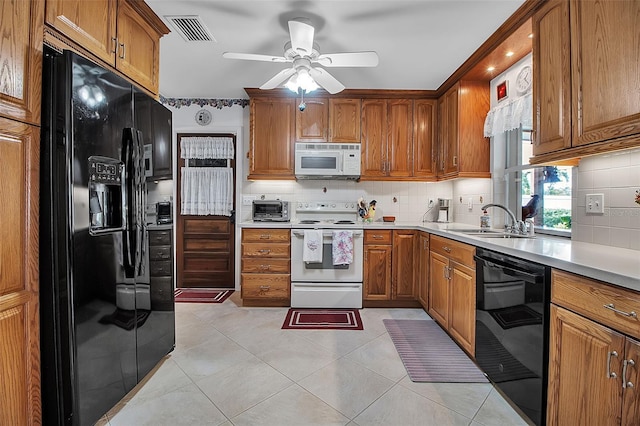 1907 76th St NW, Bradenton, FL 34209 - kitchen with black appliances, brown cabinets, ceiling fan, and light countertops