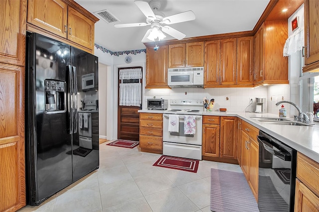 1907 76th St NW, Bradenton, FL 34209 - kitchen with black appliances, brown cabinets, backsplash, and light countertops