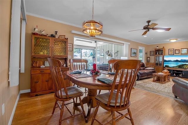 1907 76th St NW, Bradenton, FL 34209 - dining area featuring light wood-style flooring, crown molding, ceiling fan, and a chandelier