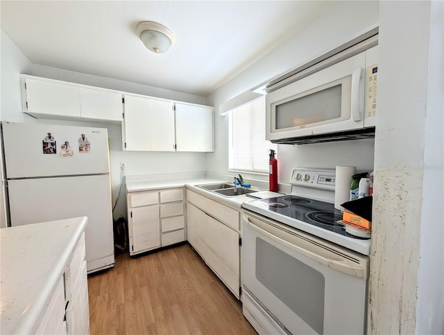 5948 Easy St Unit K35, Bradenton, FL 34207 - kitchen featuring white appliances, white cabinetry, and light countertops