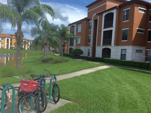 8397 38th Street Cir E Unit 305, Sarasota, FL 34243 - view of community featuring a water view and a lawn