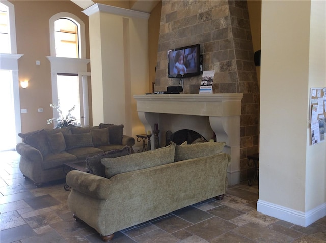 8397 38th Street Cir E Unit 305, Sarasota, FL 34243 - living area with a fireplace, stone tile floors, and a towering ceiling