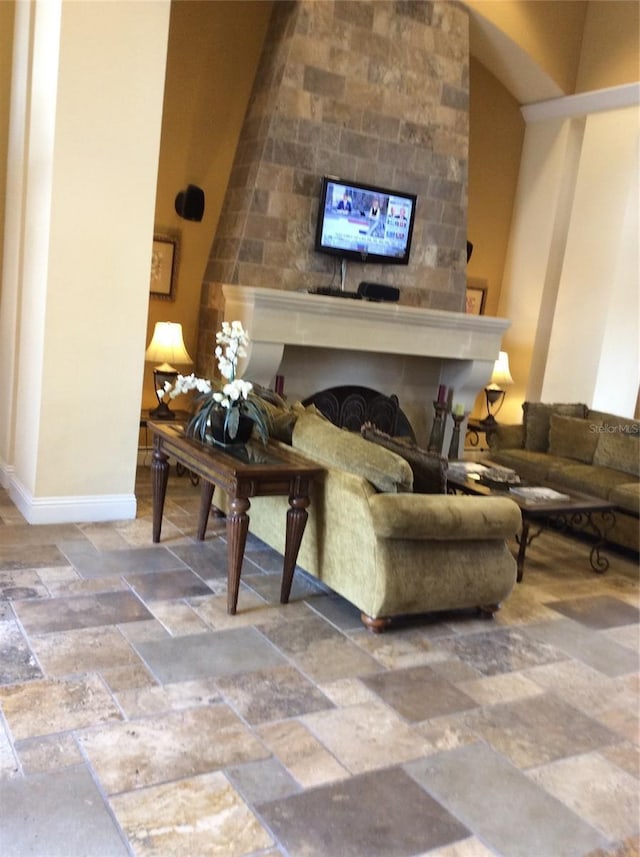 8397 38th Street Cir E Unit 305, Sarasota, FL 34243 - living area featuring stone tile flooring and a fireplace