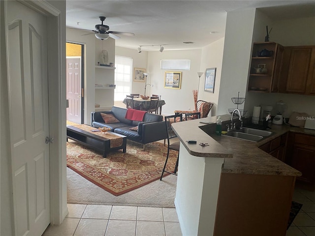 8397 38th Street Cir E Unit 305, Sarasota, FL 34243 - kitchen with light tile patterned floors, a peninsula, dark countertops, ceiling fan, and open shelves