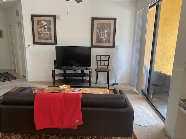 8397 38th Street Cir E Unit 305, Sarasota, FL 34243 - carpeted living area with ceiling fan and baseboards