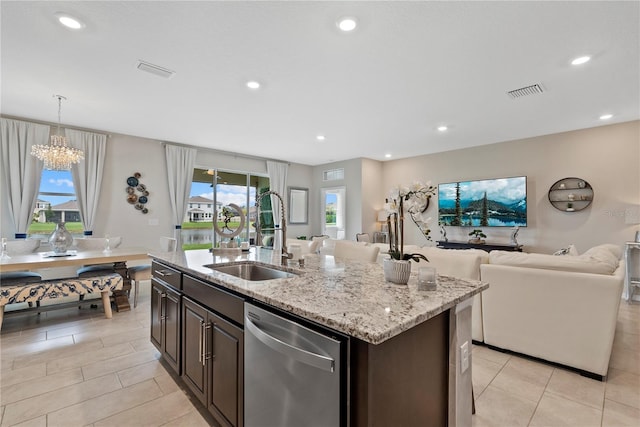 5313 Halewood Ct, Lakewood Ranch, FL 34211 - kitchen with stainless steel dishwasher, light tile patterned floors, open floor plan, a chandelier, and light stone counters