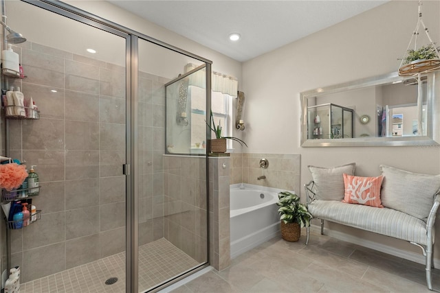 5313 Halewood Ct, Lakewood Ranch, FL 34211 - bathroom with a garden tub, a shower stall, and tile patterned floors