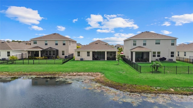 5313 Halewood Ct, Lakewood Ranch, FL 34211 - rear view of house with a sunroom, stucco siding, a fenced backyard, and a water view
