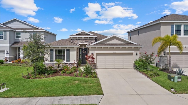 5313 Halewood Ct, Lakewood Ranch, FL 34211 - view of front of property with stucco siding, stone siding, driveway, a front yard, and a garage