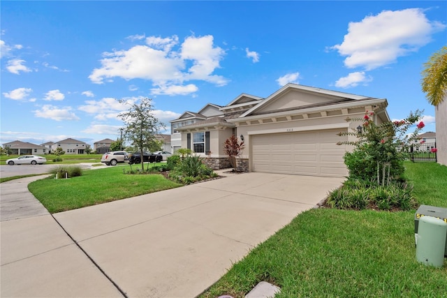 5313 Halewood Ct, Lakewood Ranch, FL 34211 - view of front facade featuring stone siding, concrete driveway, a garage, and stucco siding