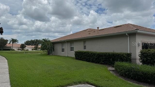 8228 Simpson Falls Ct, Sarasota, FL 34243 - view of grassy yard featuring an attached garage