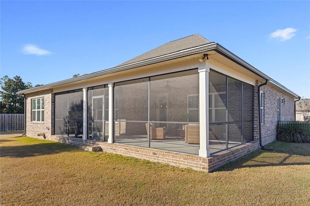 636 Meadow Lake Dr, Freeport, FL 32439 - rear view of house featuring brick siding and a sunroom