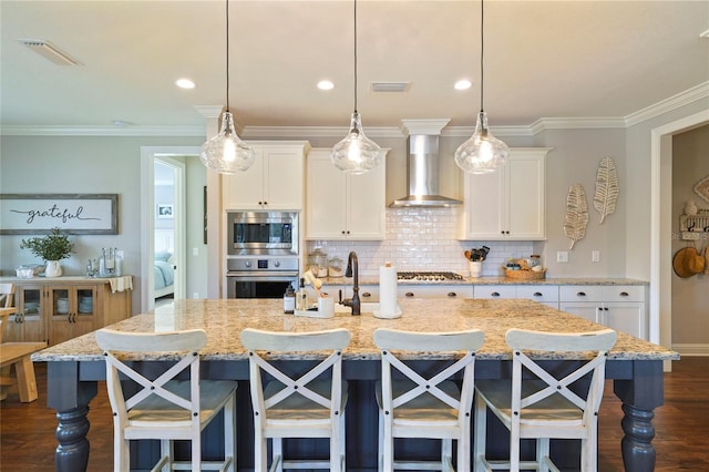 636 Meadow Lake Dr, Freeport, FL 32439 - kitchen featuring wall chimney range hood, stainless steel appliances, dark wood-style flooring, white cabinetry, and ornamental molding