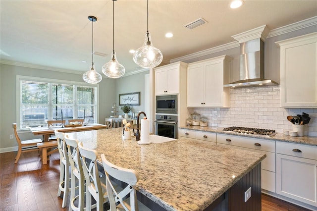 636 Meadow Lake Dr, Freeport, FL 32439 - kitchen featuring wall chimney range hood, stainless steel appliances, crown molding, tasteful backsplash, and dark wood-style floors