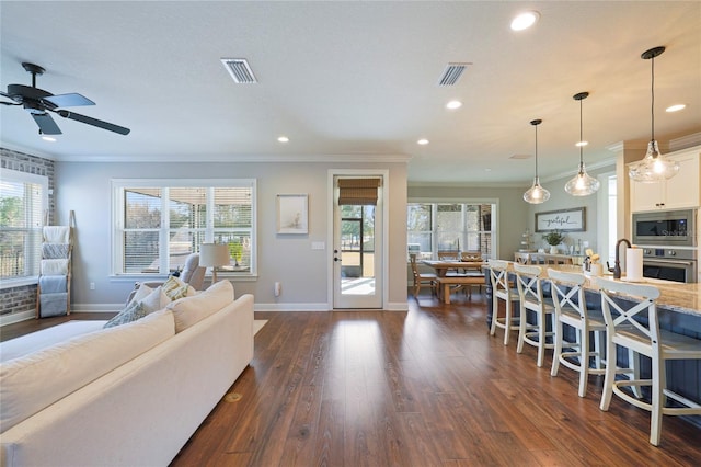 636 Meadow Lake Dr, Freeport, FL 32439 - living room featuring dark wood-type flooring, crown molding, recessed lighting, and a ceiling fan