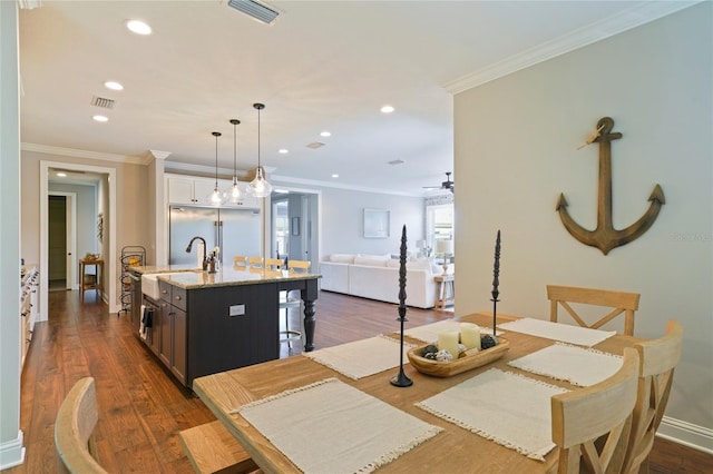 636 Meadow Lake Dr, Freeport, FL 32439 - kitchen featuring stainless steel built in refrigerator, a kitchen breakfast bar, an island with sink, light stone countertops, and recessed lighting