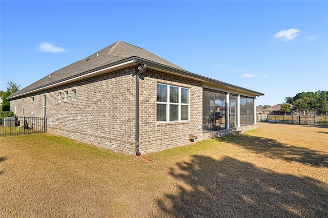 636 Meadow Lake Dr, Freeport, FL 32439 - back of property featuring brick siding, a fenced backyard, and a sunroom