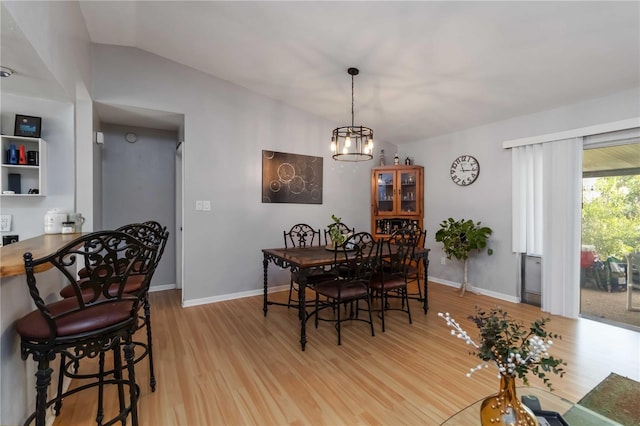616 Bryan Terrace Dr, Brandon, FL 33511 - dining area with light wood-style flooring, vaulted ceiling, and a chandelier