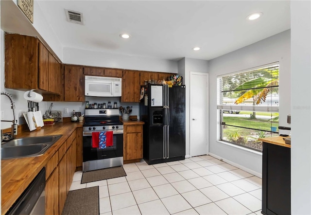 616 Bryan Terrace Dr, Brandon, FL 33511 - kitchen featuring stainless steel appliances, brown cabinetry, butcher block countertops, and recessed lighting