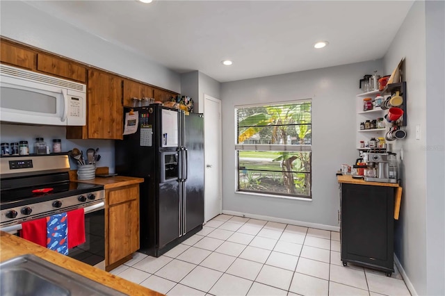 616 Bryan Terrace Dr, Brandon, FL 33511 - kitchen featuring white microwave, electric range, black refrigerator with ice dispenser, brown cabinetry, and recessed lighting