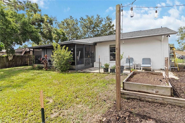 616 Bryan Terrace Dr, Brandon, FL 33511 - back of house with a sunroom, a garden, and roof with shingles