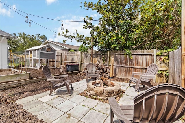 616 Bryan Terrace Dr, Brandon, FL 33511 - view of patio with an outdoor fire pit, a vegetable garden, and an outdoor structure