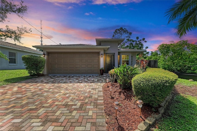 133 Tucker Ave, Sarasota, FL 34232 - view of front of home featuring decorative driveway, a garage, and stucco siding