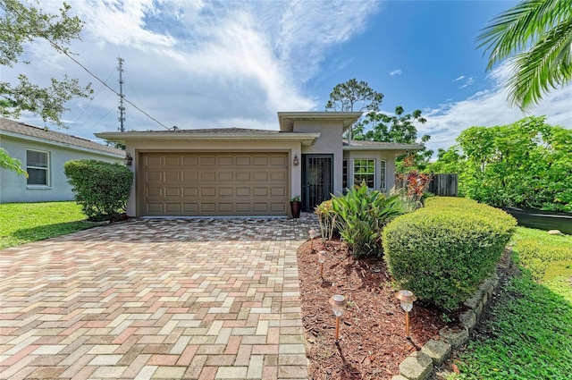 133 Tucker Ave, Sarasota, FL 34232 - view of front of property with decorative driveway, stucco siding, and a garage