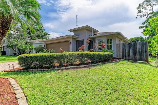 133 Tucker Ave, Sarasota, FL 34232 - view of front facade with stucco siding and an attached garage