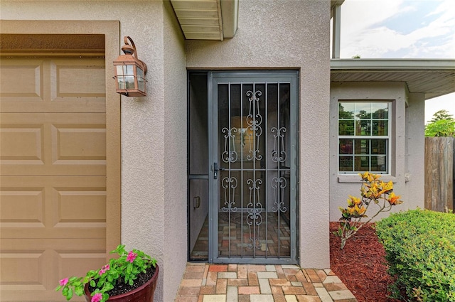 133 Tucker Ave, Sarasota, FL 34232 - property entrance with stucco siding and an attached garage